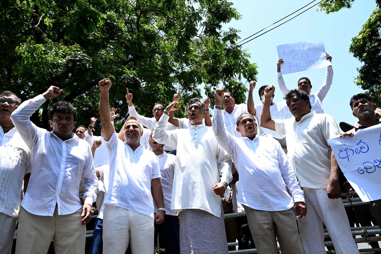 Sri Lanka's main opposition parliament members shout slogans as they protest in Colombo on April 3.